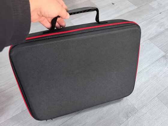 Anonymous black custom EVA carrying case exterior with red zipper