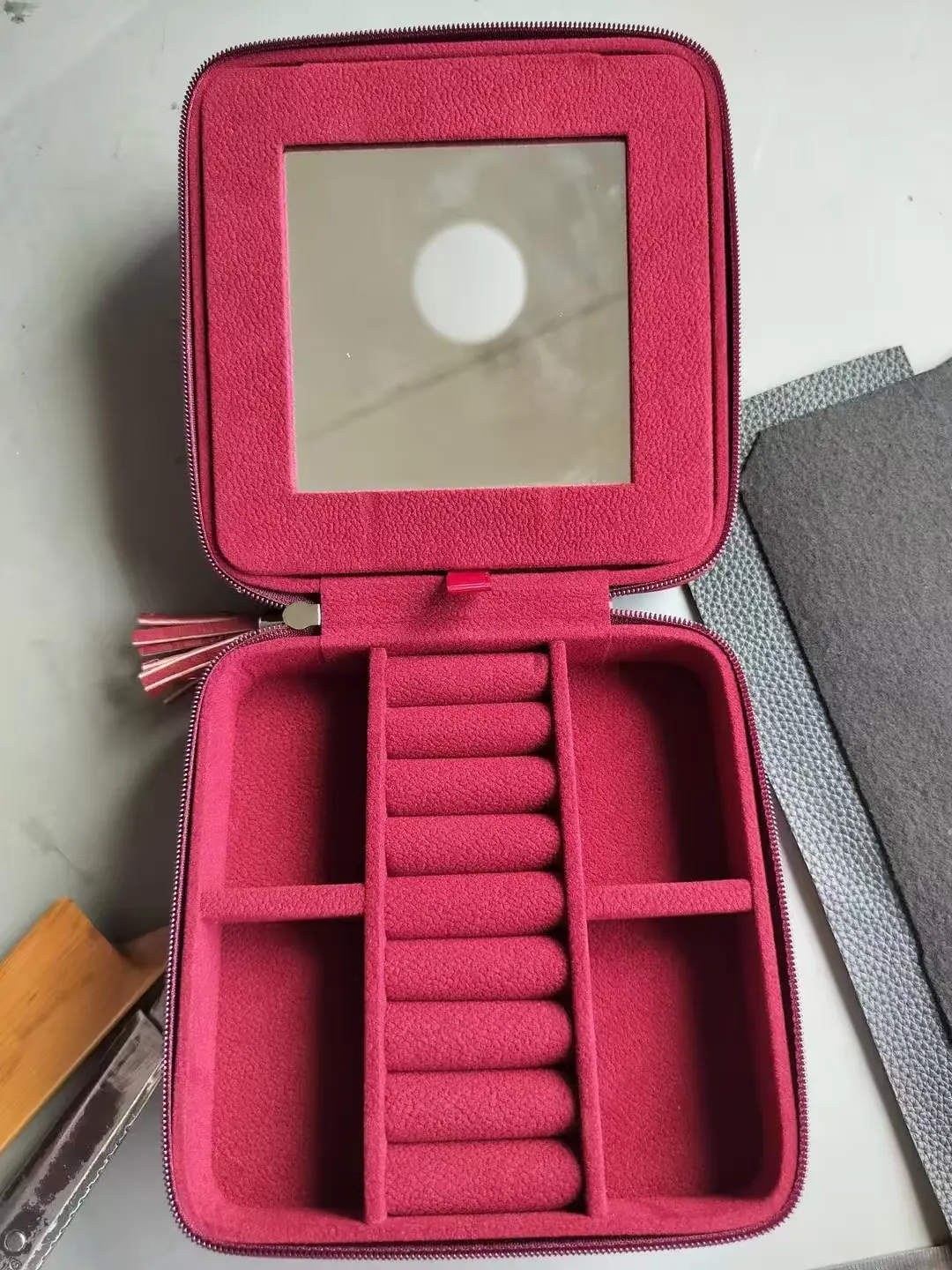 Pre-production red velvet jewelry box interior before mirror removal